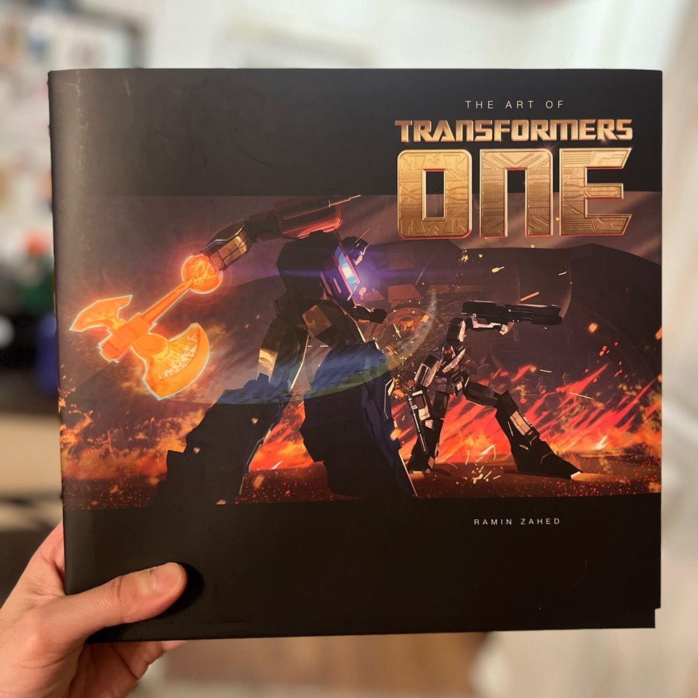 Hardcover copy of the book “The Art of Transformers One”